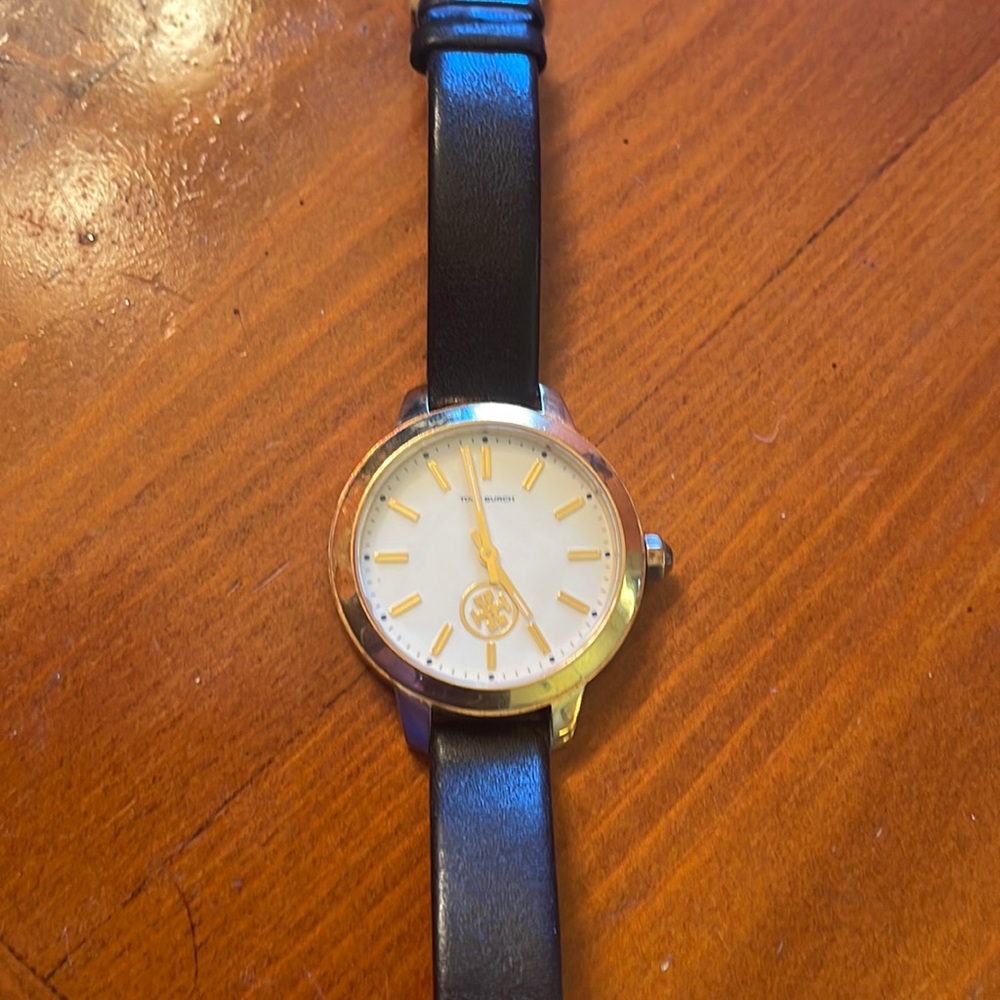 Authentic Tory Burch watch. Black band with gold and cream face. Need battery